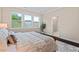 Bedroom with a plush bed, bright windows and hardwood floors at 217 Macy Grove Dr, Chapel Hill, NC 27517