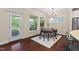 Dining area bathed in natural light, offering a view of the screened porch and access to the modern kitchen at 217 Macy Grove Dr, Chapel Hill, NC 27517