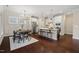 Open floor plan featuring a dining area with hardwood floors flowing into a modern kitchen with stainless steel appliances at 217 Macy Grove Dr, Chapel Hill, NC 27517