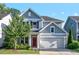 Charming two-story home with a well-manicured lawn, two car garage and a striking red front door at 217 Macy Grove Dr, Chapel Hill, NC 27517
