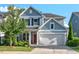 Charming two-story home with red door, landscaped front yard, and spacious garage at 217 Macy Grove Dr, Chapel Hill, NC 27517