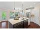 A kitchen features an island with granite countertop and stainless steel appliances at 217 Macy Grove Dr, Chapel Hill, NC 27517