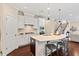 Modern kitchen with stainless steel appliances, quartz countertops, and an island with bar seating at 217 Macy Grove Dr, Chapel Hill, NC 27517