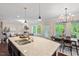 Open concept kitchen features an island with granite countertop and stainless steel sink at 217 Macy Grove Dr, Chapel Hill, NC 27517