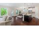 Open-concept living space with a modern kitchen, dining area, and a view of the backyard from the living area at 217 Macy Grove Dr, Chapel Hill, NC 27517