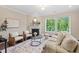 Bright and spacious living room with fireplace, comfortable seating, and large windows offering ample natural light at 217 Macy Grove Dr, Chapel Hill, NC 27517