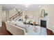 Cozy living room featuring a fireplace, stylish furniture, and an open staircase, perfect for Gathering gatherings at 217 Macy Grove Dr, Chapel Hill, NC 27517