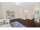 Open loft area featuring hardwood floors, two chairs, and shelving unit at 217 Macy Grove Dr, Chapel Hill, NC 27517