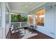Screened porch with ceiling fan and seating area for relaxing outdoors at 217 Macy Grove Dr, Chapel Hill, NC 27517