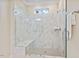 Luxurious walk-in shower featuring marble tile, a built-in bench, and a sleek glass enclosure at 217 Macy Grove Dr, Chapel Hill, NC 27517