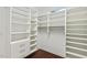 Bright walk-in closet featuring custom shelves, drawers, and stylish hardwood floors at 217 Macy Grove Dr, Chapel Hill, NC 27517