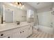 Bathroom featuring white vanity, framed mirror, and a shower and tub at 2261 Plum Frost Dr, Raleigh, NC 27603