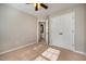 Bedroom with carpeted floor, ceiling fan, and a doorway to the bathroom at 2261 Plum Frost Dr, Raleigh, NC 27603