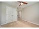 Bedroom with carpeted floor, ceiling fan, and closet at 2261 Plum Frost Dr, Raleigh, NC 27603