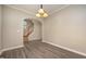 Bright dining room with hardwood floors, a stylish chandelier, and an archway to the stairs at 2261 Plum Frost Dr, Raleigh, NC 27603
