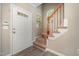 Inviting foyer featuring a staircase with wood accents and a view of the front door at 2261 Plum Frost Dr, Raleigh, NC 27603