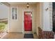 Close-up of a red front door with visible house number, light fixture, and brick accents at 2261 Plum Frost Dr, Raleigh, NC 27603