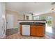 Kitchen with stainless steel sink, wood cabinets, and view to living area at 2261 Plum Frost Dr, Raleigh, NC 27603