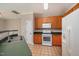Cozy kitchen featuring oak cabinets, white appliances, and tile flooring at 2261 Plum Frost Dr, Raleigh, NC 27603