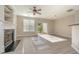 Spacious living room featuring a fireplace, ceiling fan, sliding glass doors, and wood-look flooring at 2261 Plum Frost Dr, Raleigh, NC 27603