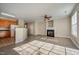 Open-concept living room with fireplace, hardwood floors, and access to the kitchen area at 2261 Plum Frost Dr, Raleigh, NC 27603