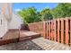 Private backyard retreat showcasing a wooden deck, brick pavers, and a wood fence at 2617 Cottage Cir, Raleigh, NC 27613