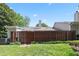 Fenced backyard featuring mature trees and lawn at 2617 Cottage Cir, Raleigh, NC 27613