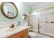 Charming bathroom with a gold-trimmed mirror and sliding glass door for the shower at 2617 Cottage Cir, Raleigh, NC 27613