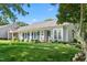 Attractive home exterior with blue shutters, lush landscaping, and a neatly maintained lawn at 2617 Cottage Cir, Raleigh, NC 27613