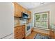 Bright kitchen with wood cabinets, granite countertops, and stainless steel microwave at 2617 Cottage Cir, Raleigh, NC 27613