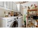 Well-equipped laundry room featuring a modern washer, dryer, and ample storage shelves at 2617 Cottage Cir, Raleigh, NC 27613