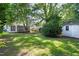 This backyard features a screened porch, storage shed, mature trees, and ample green space at 2804 Barmettler St, Raleigh, NC 27607