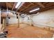 Unfinished basement with exposed ceiling, brick walls, and concrete floors with new HVAC system at 2804 Barmettler St, Raleigh, NC 27607