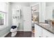 Bathroom with granite countertop, toilet, and window at 2804 Barmettler St, Raleigh, NC 27607