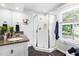 Bathroom features tile floors, glass shower, window, double vanity with granite countertop at 2804 Barmettler St, Raleigh, NC 27607