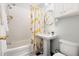 Bathroom featuring subway tiled walls, black and white tiled floors and citrus themed shower curtain at 2804 Barmettler St, Raleigh, NC 27607