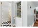 Hallway bathroom featuring subway tile walls, cheerful citrus shower curtain, and a linen closet at 2804 Barmettler St, Raleigh, NC 27607