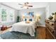 Comfortable bedroom with ceiling fan, large windows, and wood floors at 2804 Barmettler St, Raleigh, NC 27607