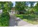 Home exterior with mature landscaping, inviting curb appeal, driveway, and plenty of privacy from the street at 2804 Barmettler St, Raleigh, NC 27607