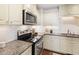 Modern kitchen featuring stainless steel appliances, granite countertops, and classic white cabinetry at 2804 Barmettler St, Raleigh, NC 27607