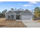 Charming one-story home with gray siding, a two-car garage, and a well-manicured lawn at 294 Pretty Run Branch Ln, Wendell, NC 27591