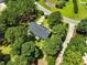 Aerial view of the house with mature trees and driveway at 3109 Gold Dust Ln, Willow Springs, NC 27592