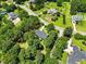 Aerial view showing the house nestled amongst mature trees at 3109 Gold Dust Ln, Willow Springs, NC 27592