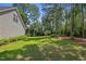 Spacious backyard with lush greenery and mature trees at 3109 Gold Dust Ln, Willow Springs, NC 27592