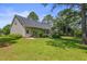 Home exterior with a manicured lawn, landscaping, and deck at 3109 Gold Dust Ln, Willow Springs, NC 27592