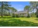 Well-maintained lawn with mature trees and home exterior at 3109 Gold Dust Ln, Willow Springs, NC 27592
