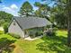 Aerial view of back of the house highlighting a patio, garden, and lawn at 3109 Gold Dust Ln, Willow Springs, NC 27592