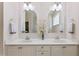 Elegant bathroom featuring a double vanity with decorative flowers and arched mirrors at 3109 Gold Dust Ln, Willow Springs, NC 27592