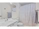 Cozy bathroom with a white vanity, toilet, patterned shower curtain, and neutral tones at 3109 Gold Dust Ln, Willow Springs, NC 27592