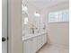 Elegant bathroom featuring a double vanity with decorative flowers and a decorative glass block window at 3109 Gold Dust Ln, Willow Springs, NC 27592